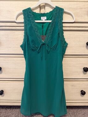 Sleeveless chiffon mini dress with lace trim neckline + tie front